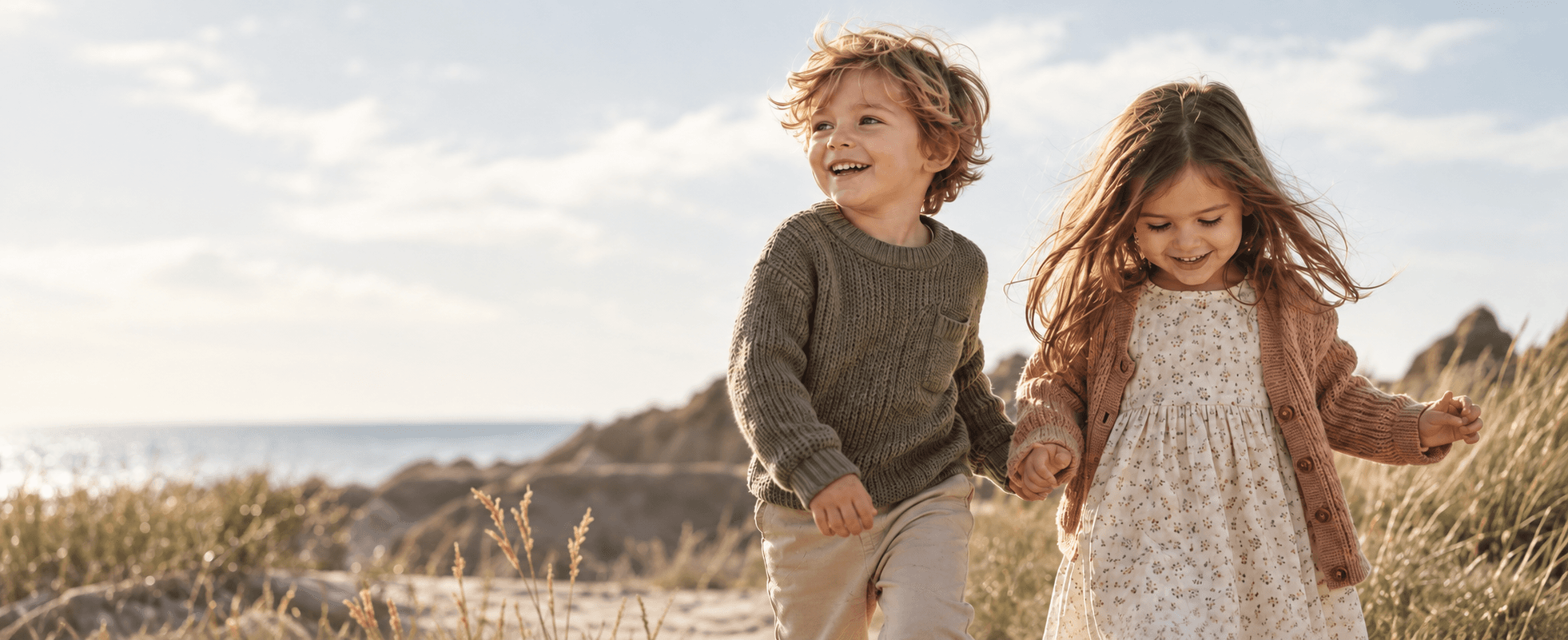 Two little explorers sharing a happy moment on the coast